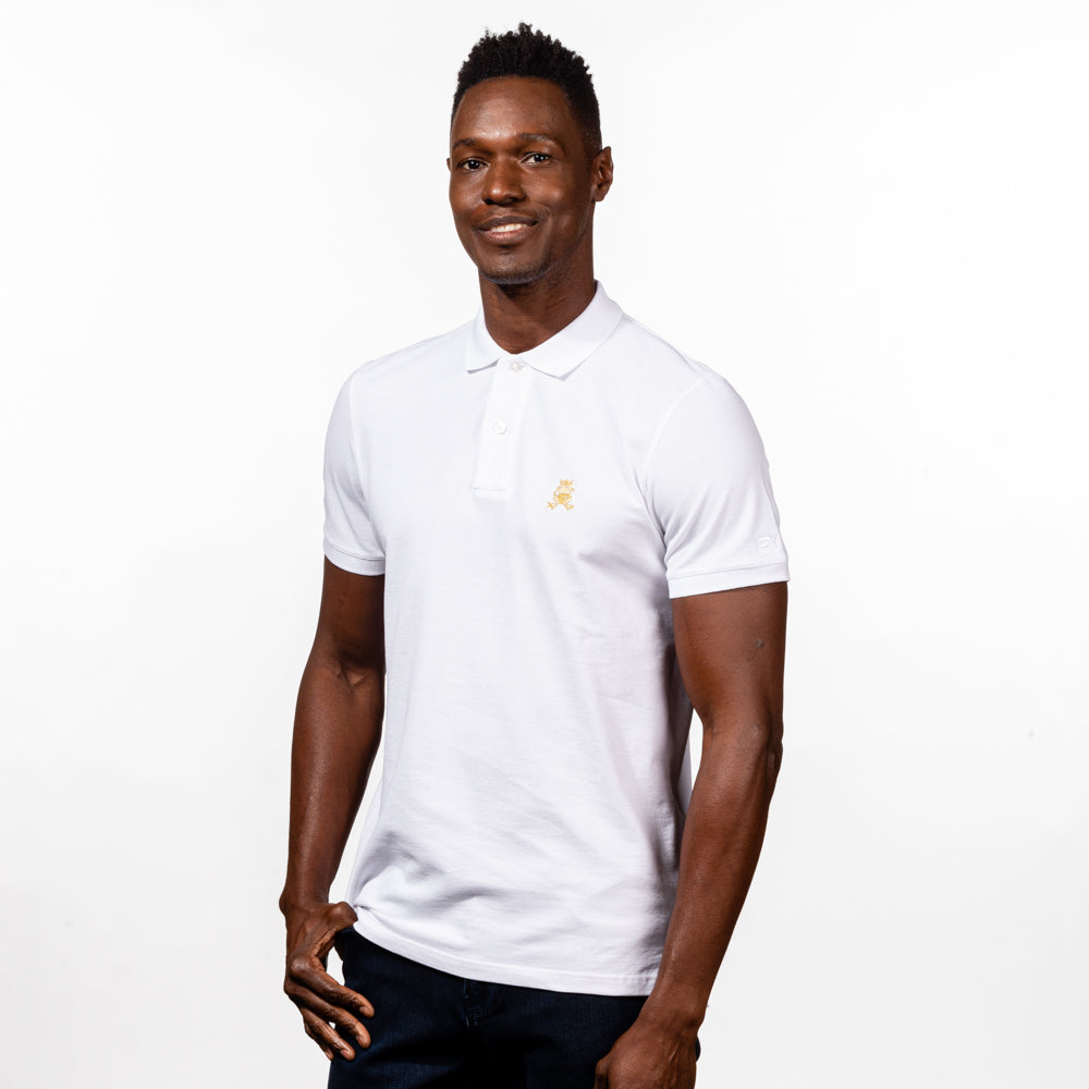 Model in white  polo with two-button placket, ribbed armbands, and embroidered gold frog mascot. 
