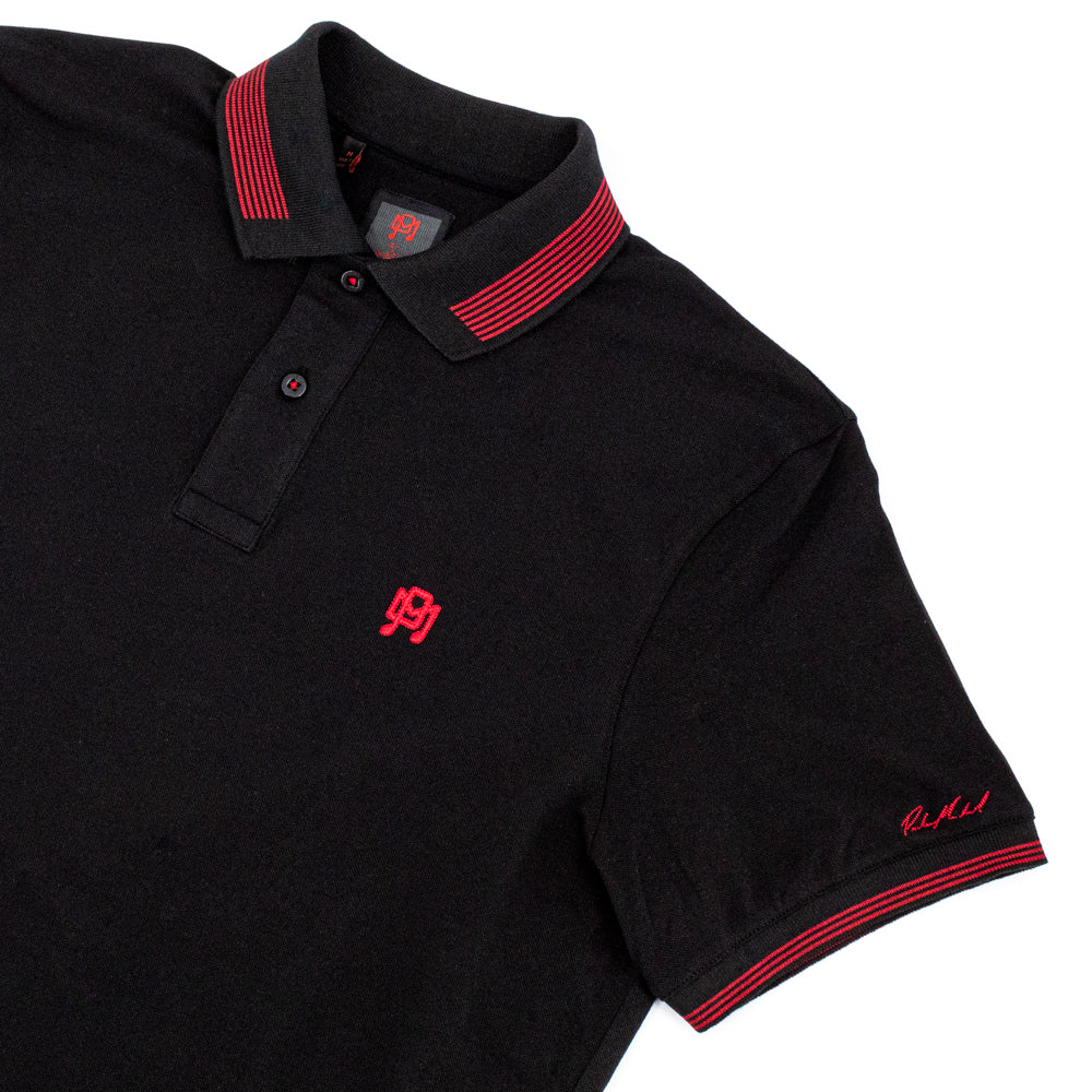 Flat-lay of a Black Polo with Red Accents.